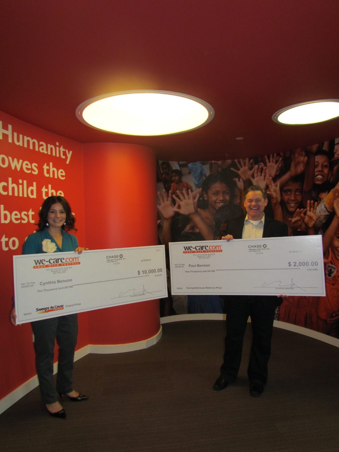 Cynthia and Paul Benson holding their We-Care Sweeps 4a Cause winning checks
