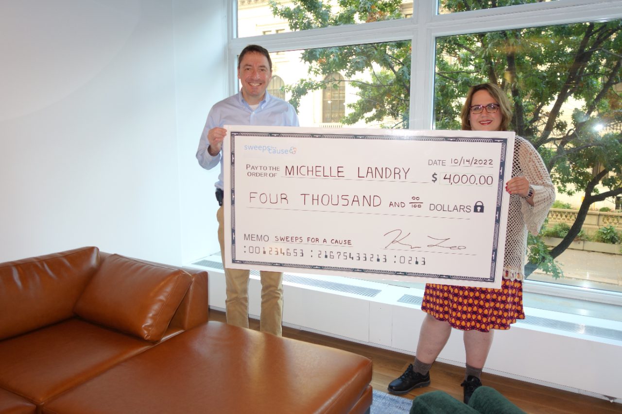 Michelle Landry receiving her Sweeps for a Cause winning check