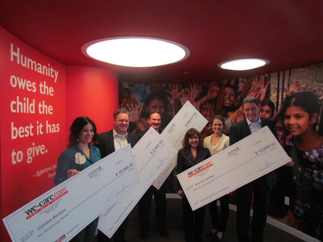 The We-Care team presenting the Save the Children $12,000 donation check
